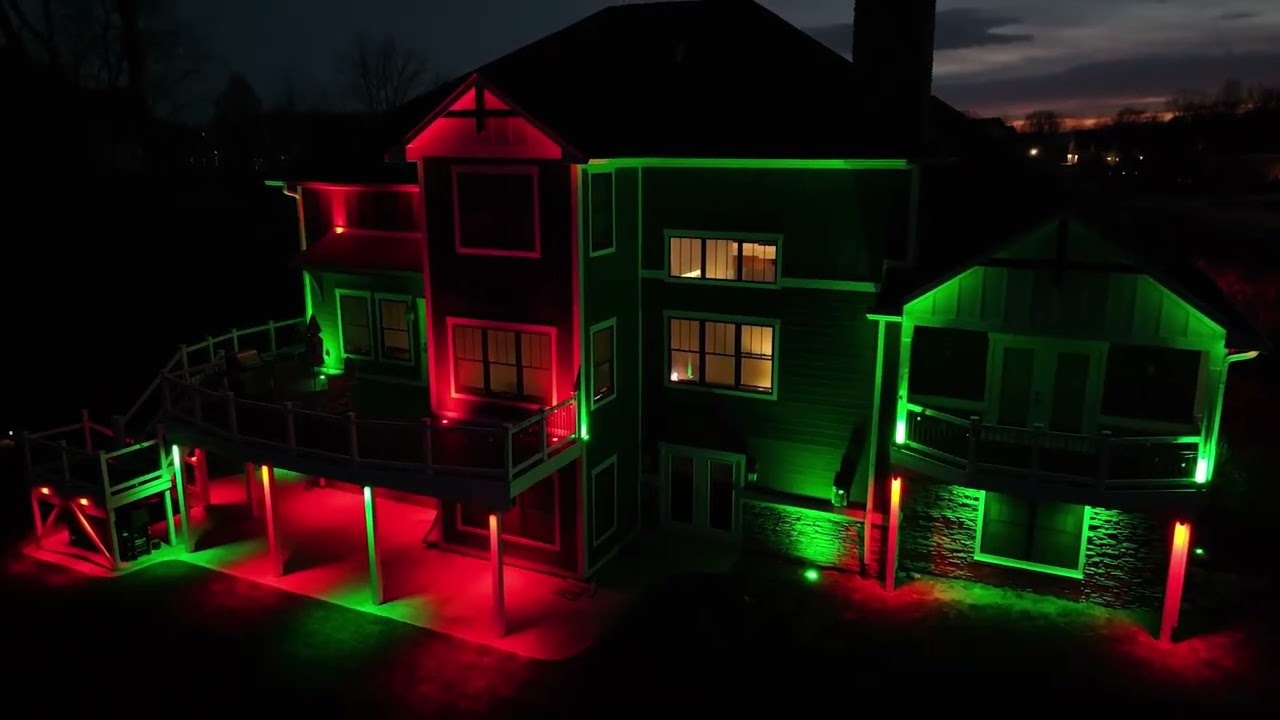 A home in Arkansas at dusk with its Elevate permanent lighting running a red and green scene
